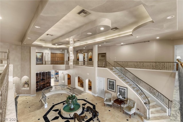 2785 S Monte Cristo Way, Las Vegas, NV 89117 - living room with a tray ceiling, recessed lighting, inlaid floor details, and baseboards