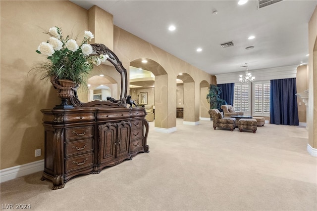 interior space with a notable chandelier and light carpet