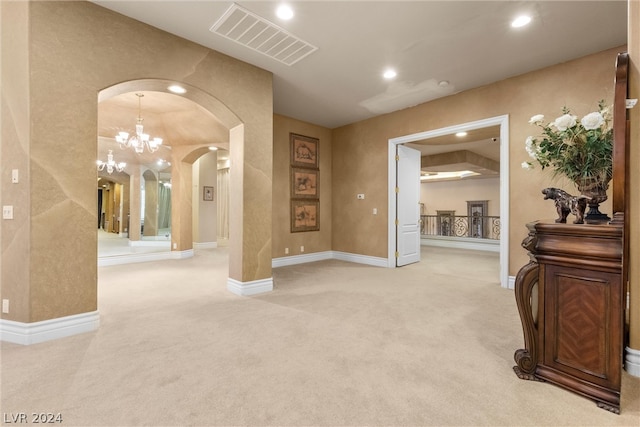 interior space featuring carpet floors and an inviting chandelier