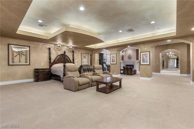 living room featuring carpet and a tray ceiling