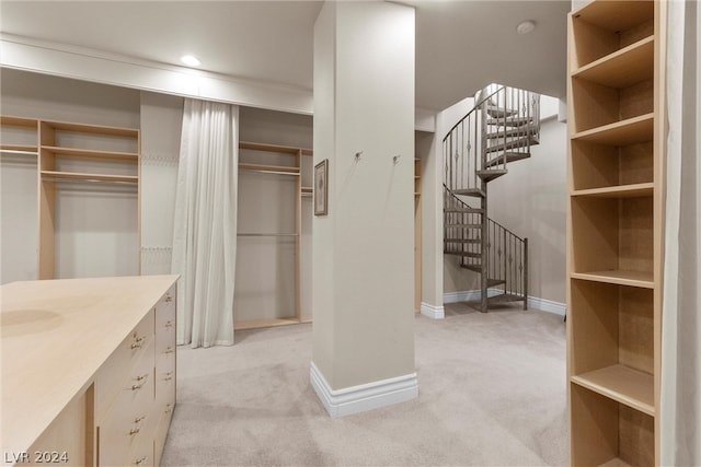 spacious closet featuring light carpet