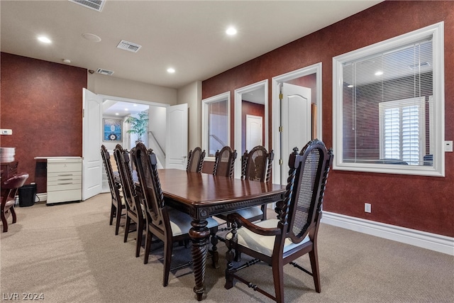 dining space with light carpet