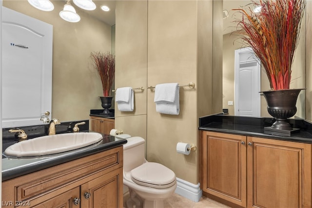 bathroom with tile patterned flooring, toilet, and vanity