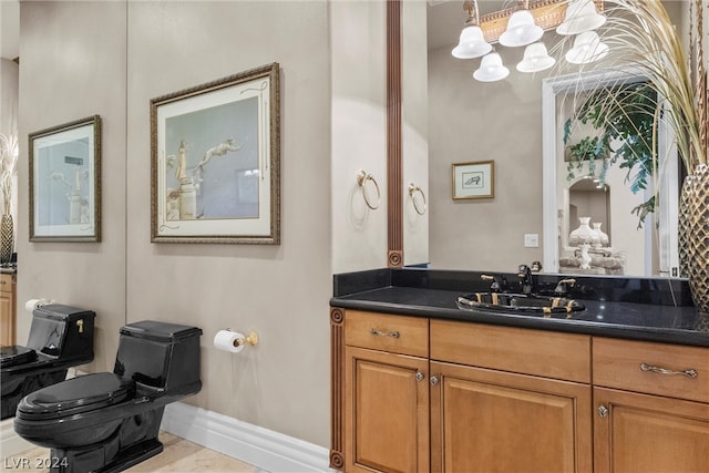 bathroom featuring tile patterned floors, vanity, and toilet