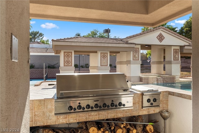 view of patio / terrace with area for grilling, grilling area, and a fenced in pool