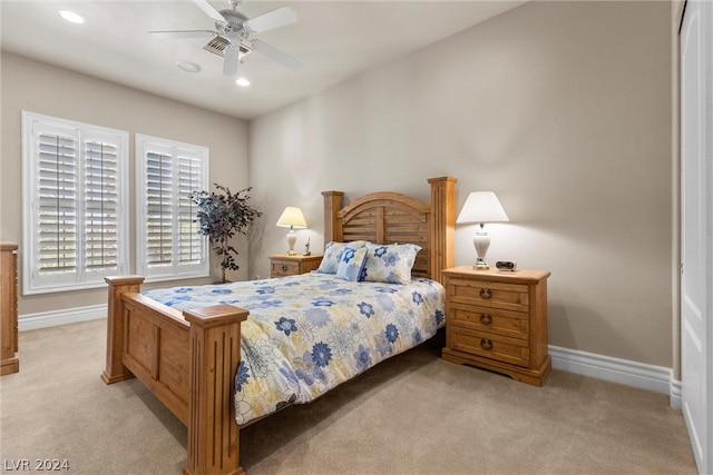 bedroom with light carpet and ceiling fan