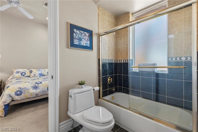 bathroom with toilet, ceiling fan, enclosed tub / shower combo, and tile patterned flooring