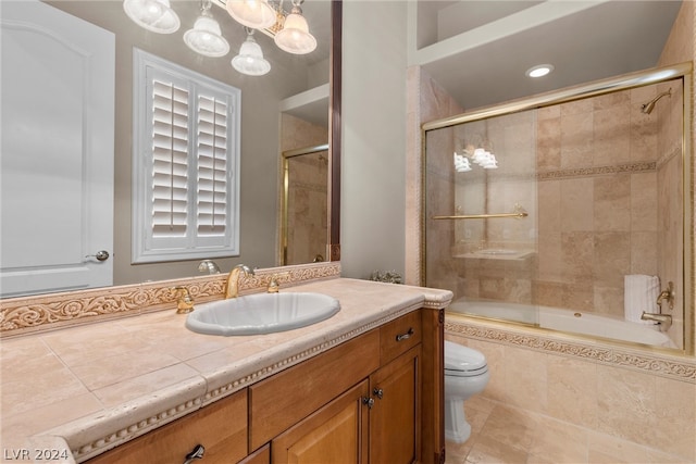 full bathroom with bath / shower combo with glass door, tile patterned floors, toilet, and vanity