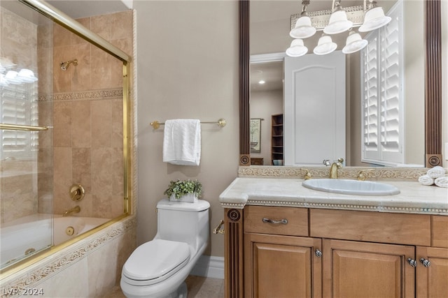 full bathroom with vanity, shower / bath combination with glass door, and toilet