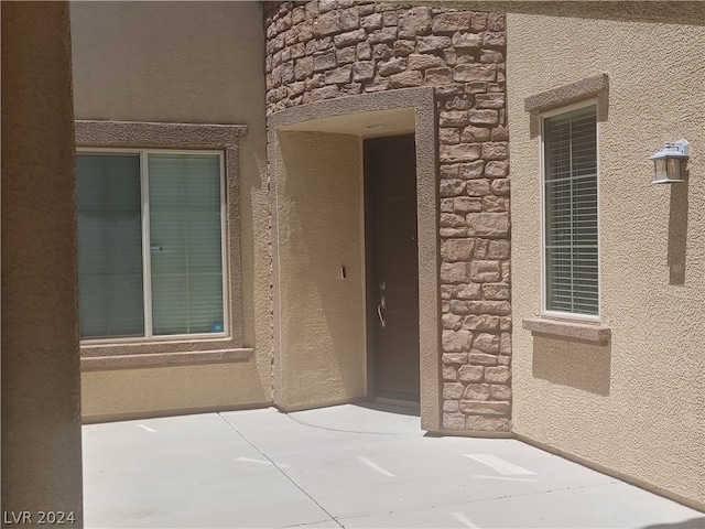 doorway to property with a patio area