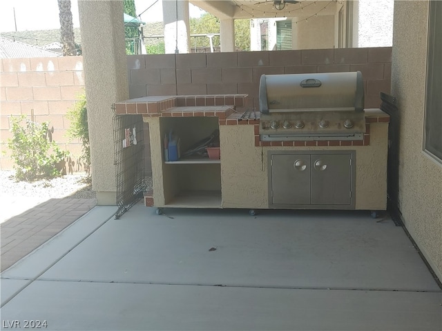 view of terrace featuring an outdoor kitchen and grilling area