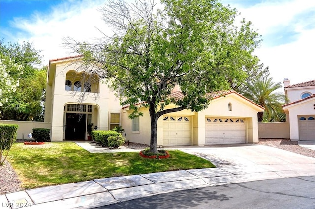 mediterranean / spanish-style home with a front yard and a garage