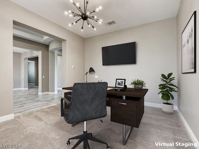 office space featuring light carpet and an inviting chandelier