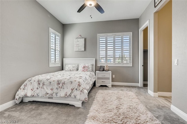 bedroom featuring ceiling fan and light carpet