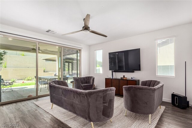 living room with ceiling fan, a healthy amount of sunlight, and wood-type flooring