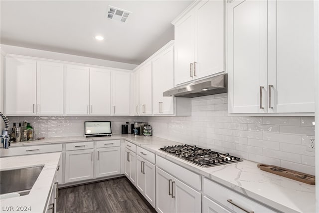 kitchen featuring white cabinets, dark wood-type flooring, sink, light stone counters, and stainless steel gas stovetop