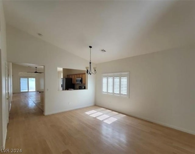 interior space with lofted ceiling, light hardwood / wood-style floors, and a notable chandelier