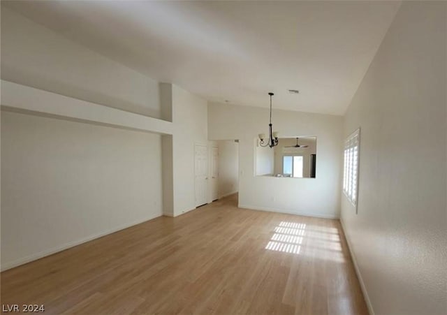 interior space featuring high vaulted ceiling, hardwood / wood-style floors, and a chandelier