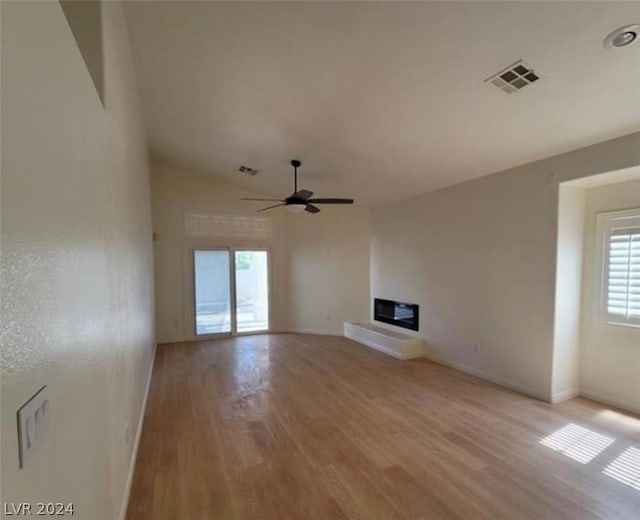 unfurnished living room featuring ceiling fan, light hardwood / wood-style flooring, and lofted ceiling