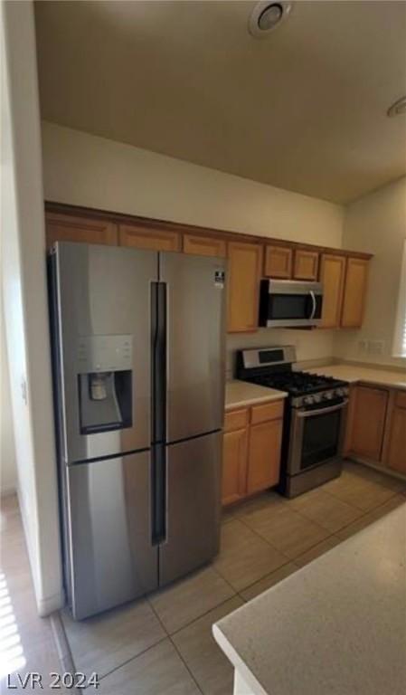 kitchen featuring appliances with stainless steel finishes and light tile patterned flooring