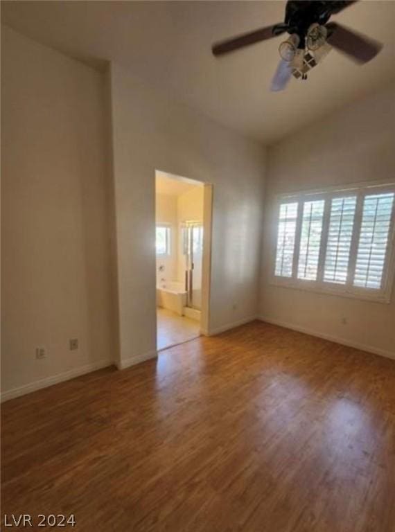 spare room featuring ceiling fan, vaulted ceiling, and hardwood / wood-style floors