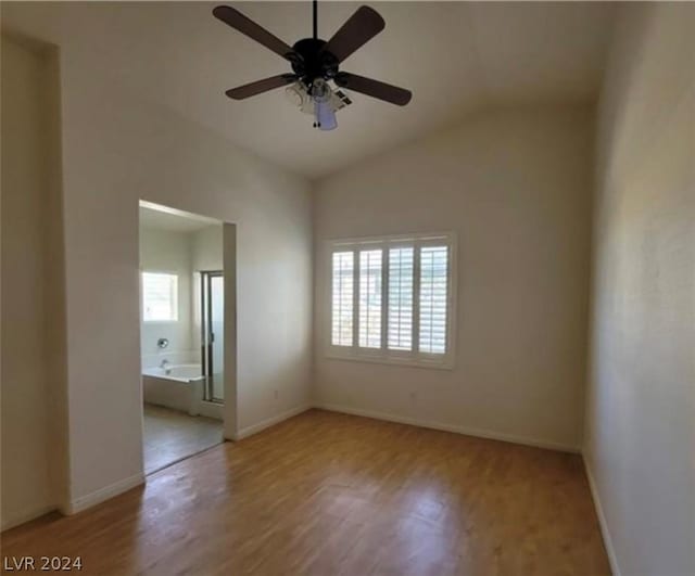 empty room featuring vaulted ceiling, ceiling fan, and light wood-type flooring