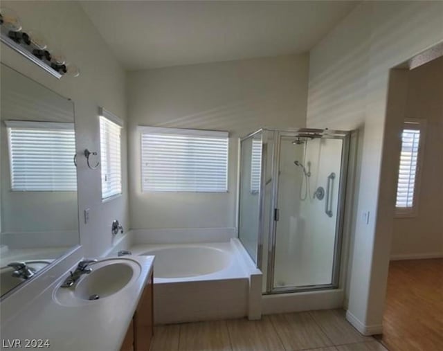 bathroom with vanity and independent shower and bath