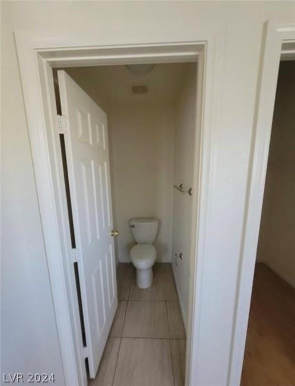 bathroom featuring toilet and tile patterned floors