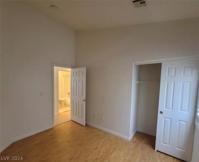 unfurnished bedroom with a closet and light hardwood / wood-style flooring