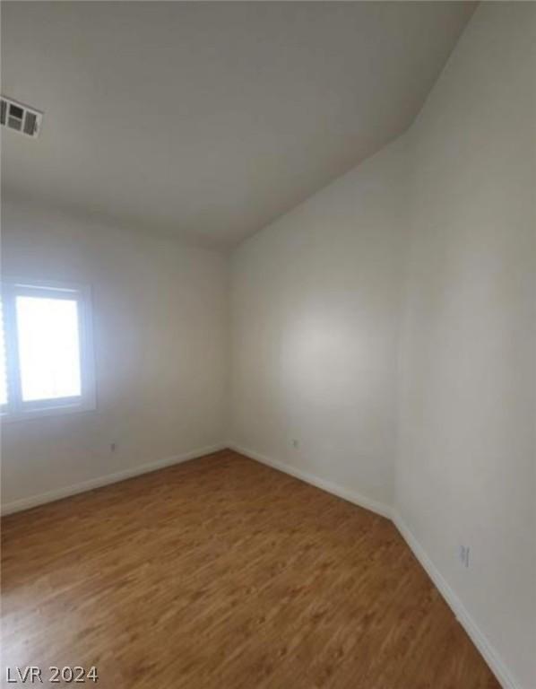 spare room featuring hardwood / wood-style floors