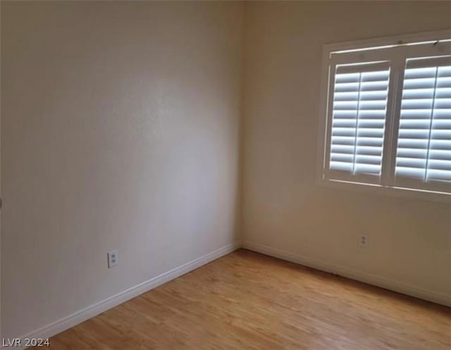 unfurnished room with light wood-type flooring