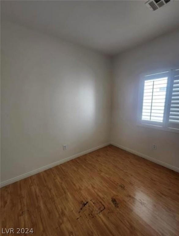 spare room with hardwood / wood-style floors