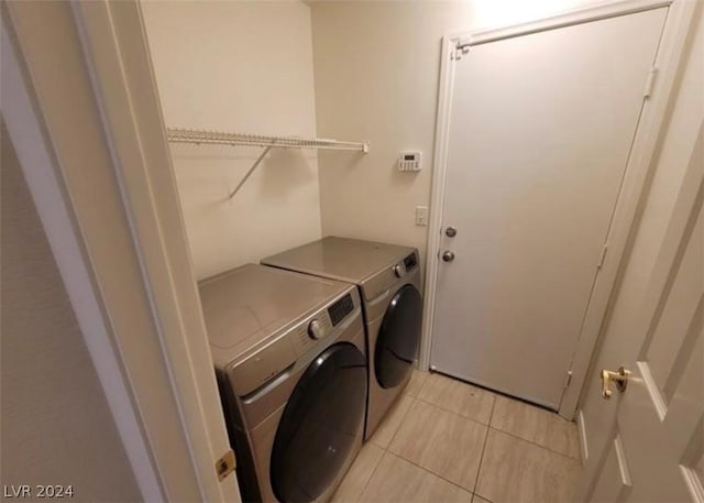 washroom with washing machine and dryer and light tile patterned flooring