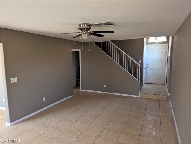 interior space with light tile patterned floors and ceiling fan