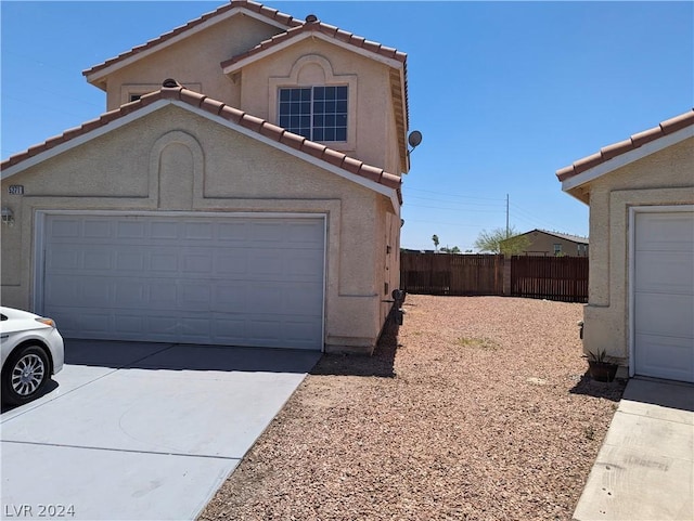 view of side of home with a garage