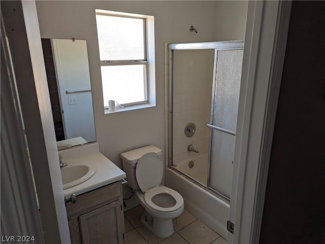 full bathroom with tile patterned flooring, vanity, toilet, and shower / bath combination with glass door