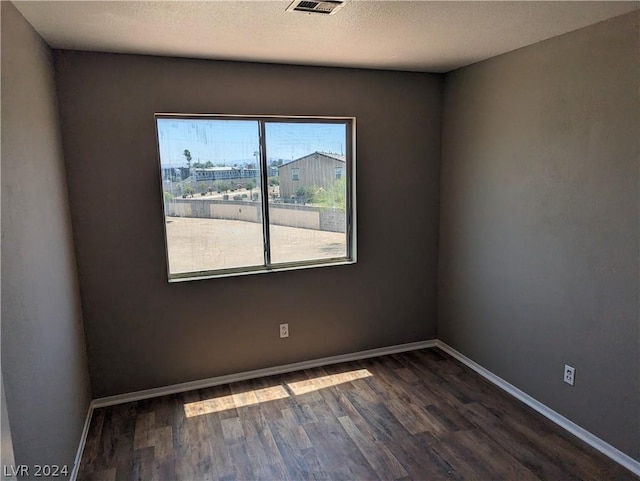 empty room with dark wood-type flooring