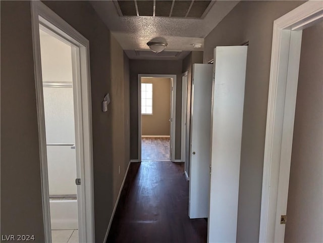 corridor with a textured ceiling