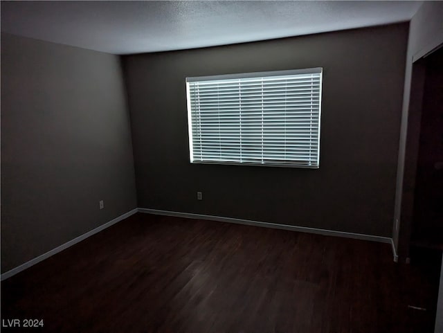 unfurnished room featuring dark hardwood / wood-style flooring