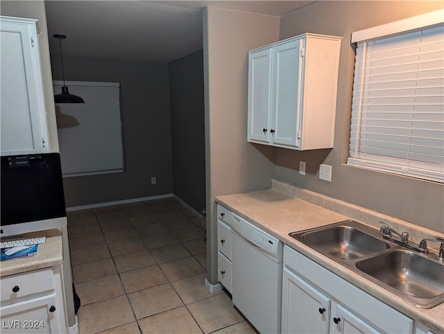 kitchen featuring white cabinetry, sink, white dishwasher, decorative light fixtures, and light tile patterned floors