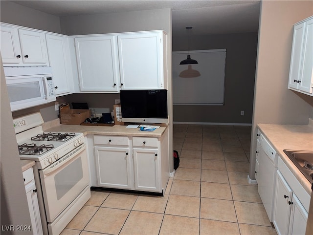 kitchen featuring white cabinetry, light tile patterned floors, pendant lighting, and white appliances