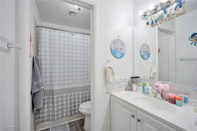 bathroom featuring vanity, backsplash, toilet, and a shower with shower curtain