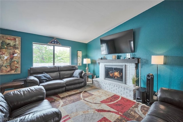 living room with lofted ceiling and a brick fireplace