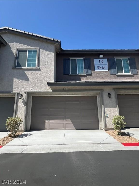 multi unit property featuring a garage