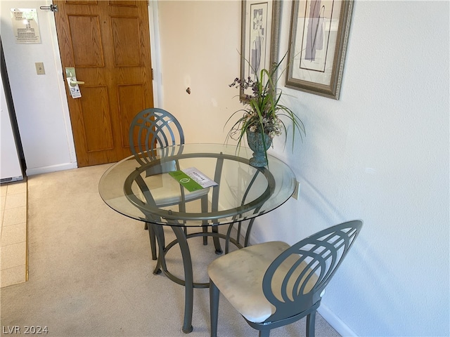 dining space featuring light colored carpet