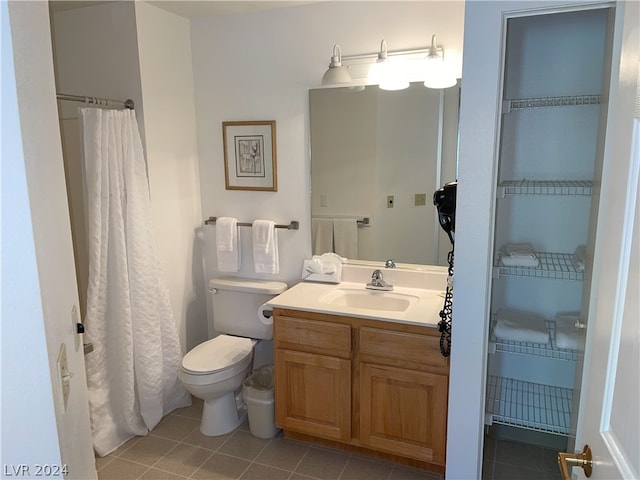 bathroom featuring tile patterned flooring, vanity, and toilet