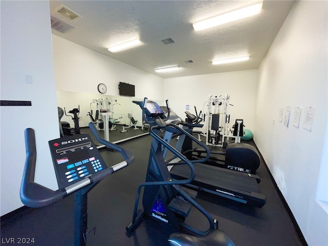 gym featuring a textured ceiling