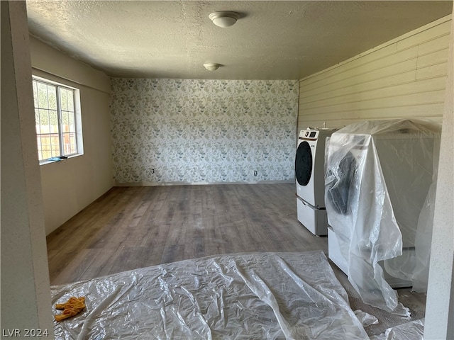 interior space featuring washer / dryer, a textured ceiling, and dark hardwood / wood-style flooring