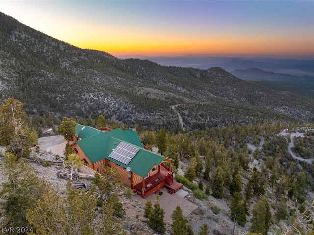 aerial view at dusk featuring a mountain view