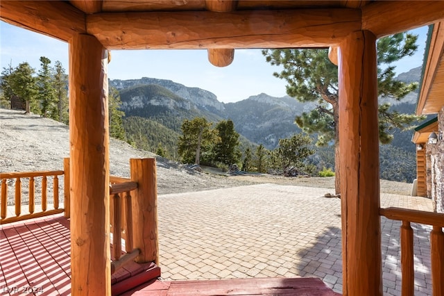 deck with a mountain view and a patio area